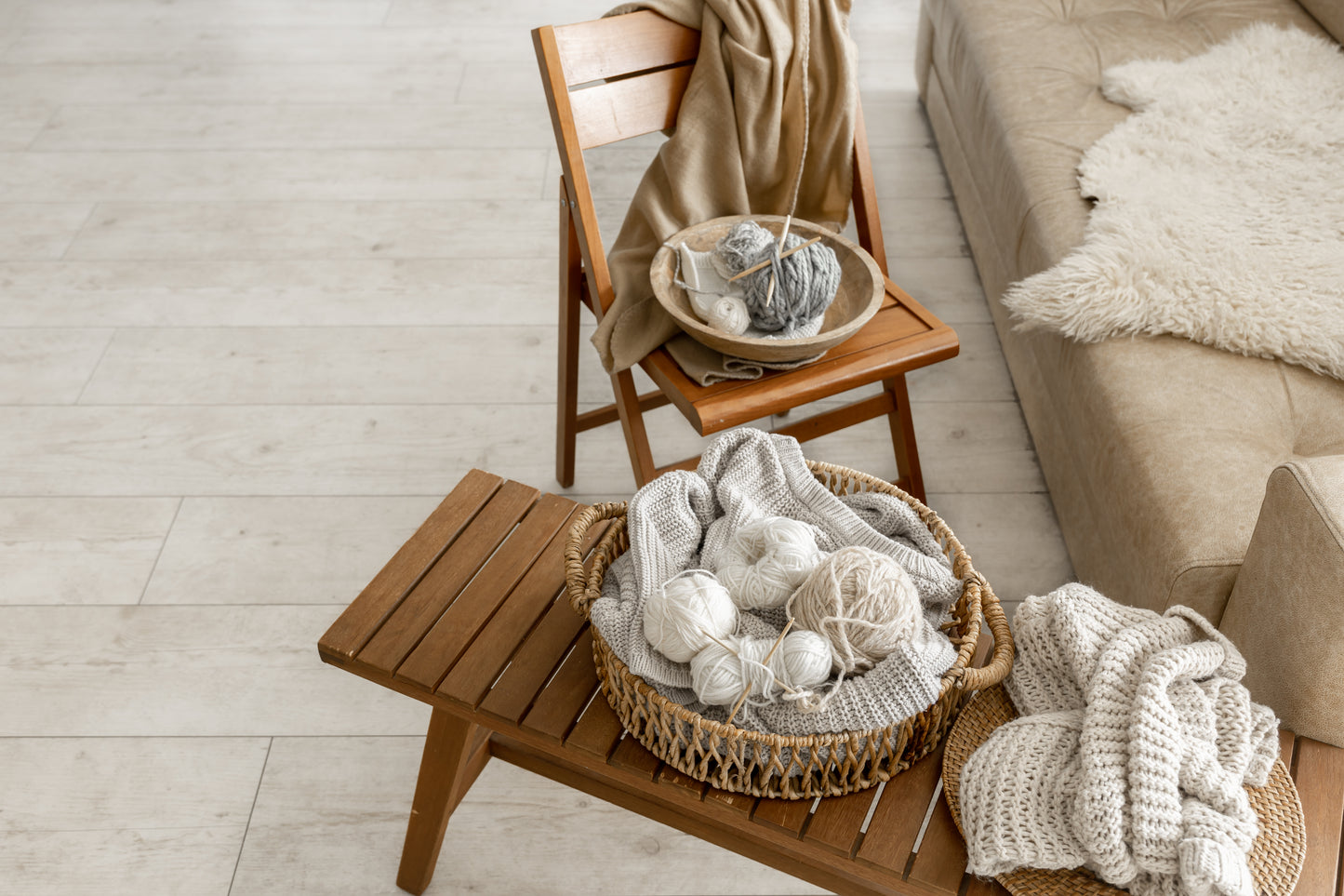 Yarn balls lay in a basket on top of a table